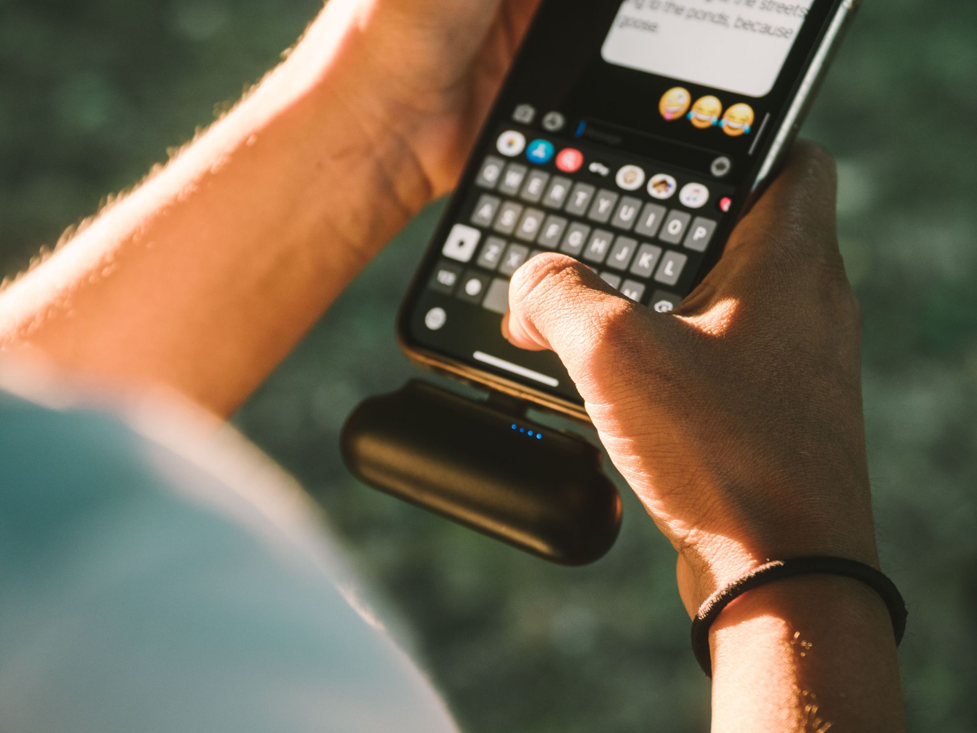Customer charging a phone from a printed power bank in warm evening light